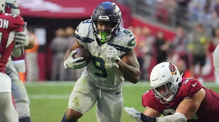 Nov 6, 2022; Phoenix, AZ, United States; Seattle Seahawks running back Kenneth Walker III (9) runs past Arizona Cardinals defensive lineman Zach Allen (94) at State Farm Stadium.